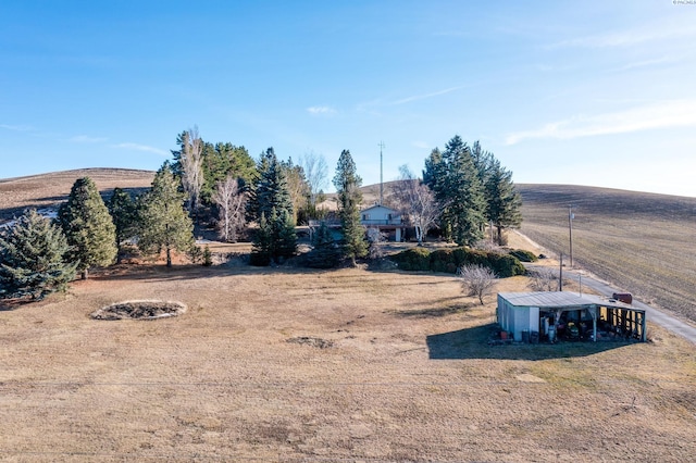 view of yard with an outbuilding and a rural view