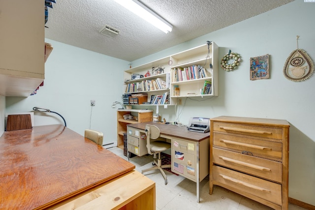 home office with light floors, visible vents, baseboard heating, and a textured ceiling