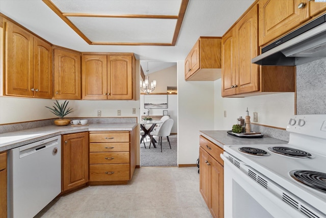 kitchen featuring white appliances, under cabinet range hood, light countertops, and decorative light fixtures