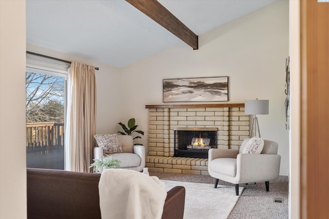 carpeted living area with lofted ceiling with beams and a fireplace