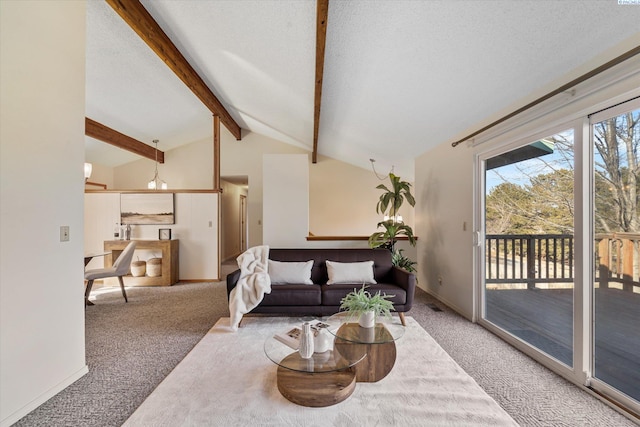 carpeted living room featuring baseboards, lofted ceiling with beams, and a textured ceiling