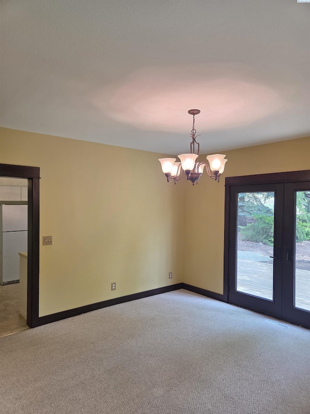 6302 Sand Rd, Pullman, WA 99163 - carpeted empty room with french doors, a chandelier, and baseboards