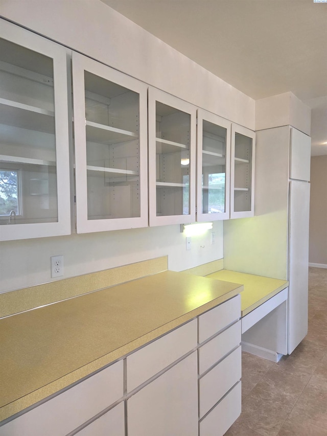 6302 Sand Rd, Pullman, WA 99163 - kitchen with light countertops, glass insert cabinets, and baseboards