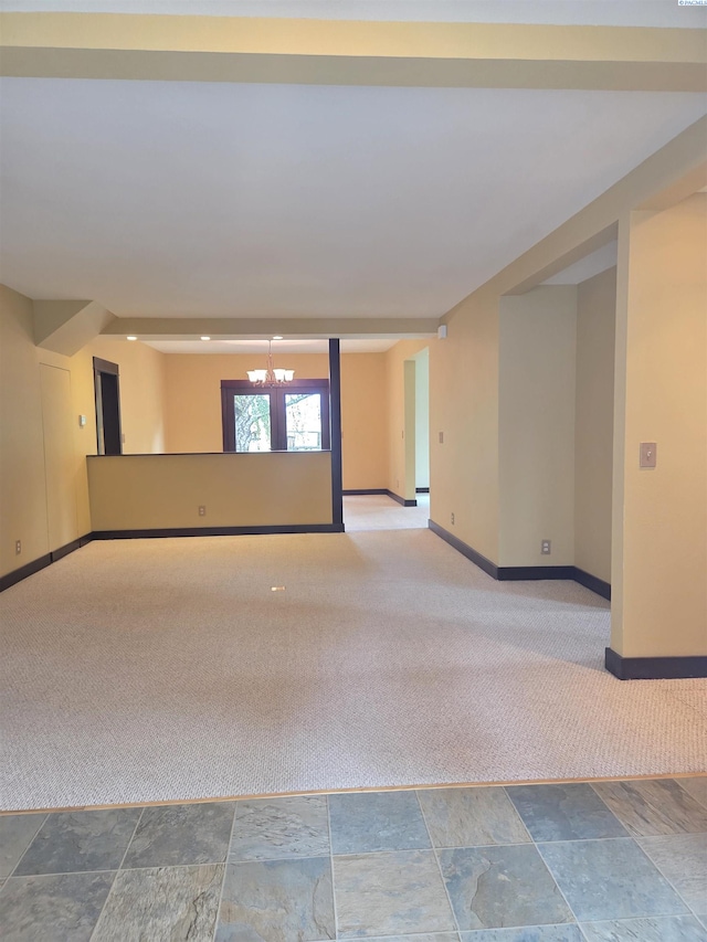 6302 Sand Rd, Pullman, WA 99163 - unfurnished room with carpet floors, baseboards, a chandelier, and stone finish floors