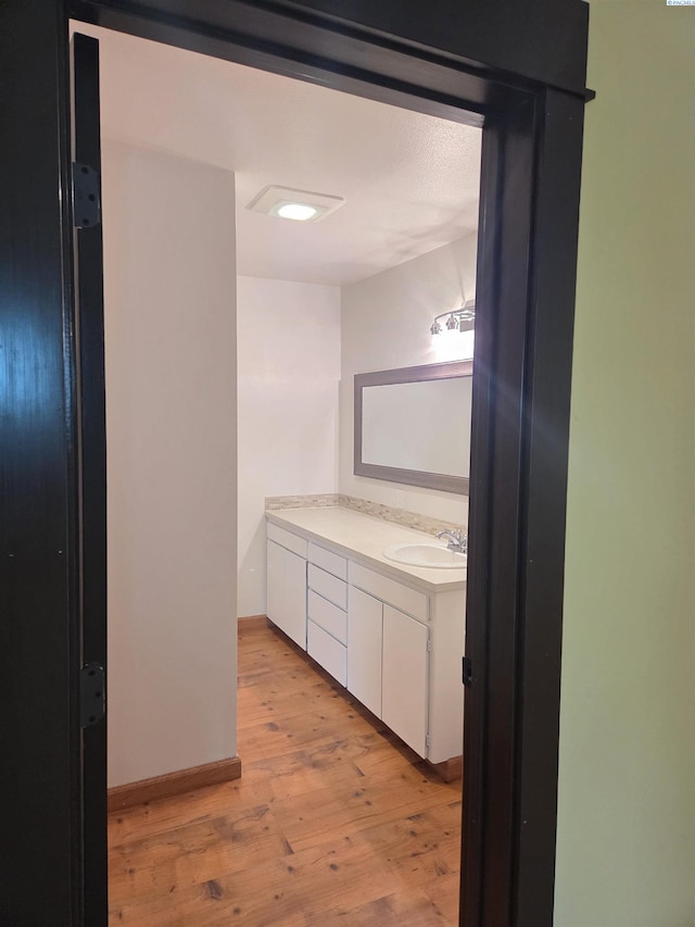 6302 Sand Rd, Pullman, WA 99163 - bathroom featuring vanity, wood finished floors, and baseboards