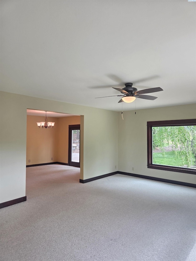 6302 Sand Rd, Pullman, WA 99163 - unfurnished room featuring a chandelier, light carpet, plenty of natural light, and baseboards