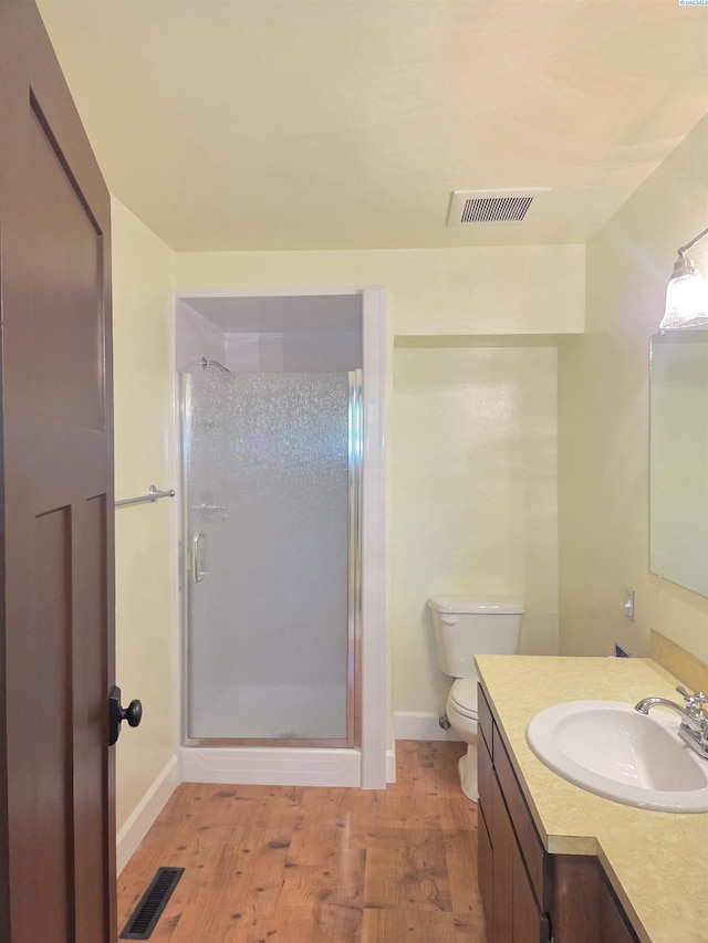 6302 Sand Rd, Pullman, WA 99163 - bathroom featuring a stall shower, wood finished floors, vanity, toilet, and baseboards