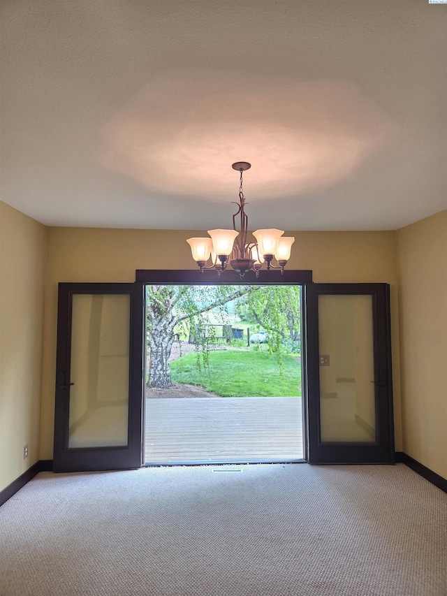 6302 Sand Rd, Pullman, WA 99163 - empty room with carpet, baseboards, and a chandelier