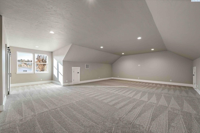 4402 Everett St, West Richland, WA 99353 - bonus room featuring vaulted ceiling, light colored carpet, and a textured ceiling