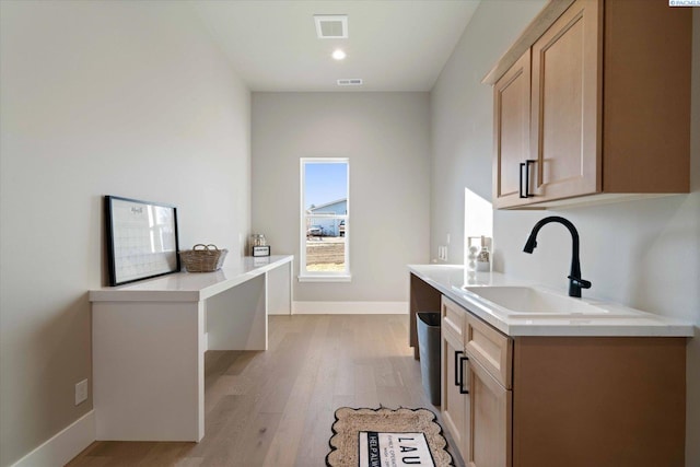4402 Everett St, West Richland, WA 99353 - kitchen featuring light brown cabinetry, sink, and light hardwood / wood-style flooring