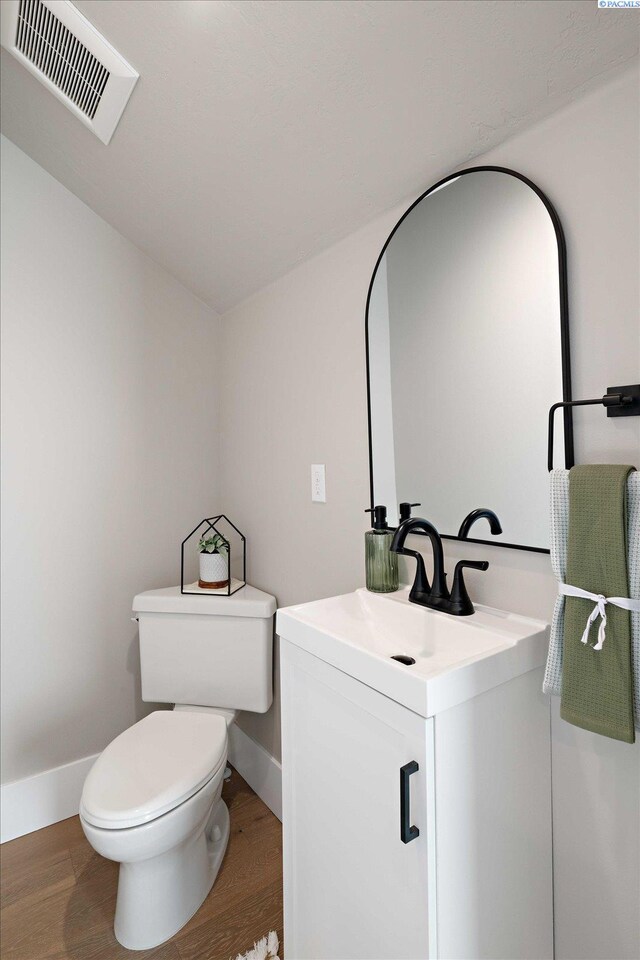 4402 Everett St, West Richland, WA 99353 - bathroom with vanity, hardwood / wood-style floors, and toilet