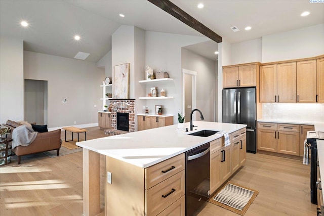 4402 Everett St, West Richland, WA 99353 - kitchen with light brown cabinetry, light wood-type flooring, stainless steel fridge, dishwasher, and a kitchen island with sink