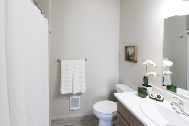 1200 N 8th Ave Unit A204, Othello, WA 99327 - bathroom featuring vanity, heating unit, wood finished floors, and curtained shower