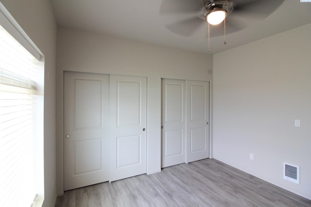 1200 N 8th Ave Unit A204, Othello, WA 99327 - unfurnished bedroom with wood finished floors, two closets, and a ceiling fan