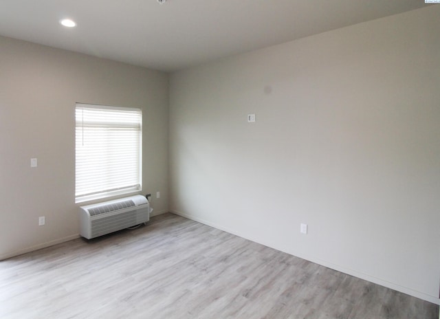 1200 N 8th Ave Unit A204, Othello, WA 99327 - unfurnished room featuring light wood-style flooring, recessed lighting, and a wall unit AC
