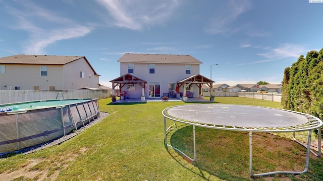 5802 Sidon Ln, Pasco, WA 99301 - fenced backyard featuring a gazebo and a trampoline
