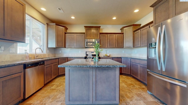 5802 Sidon Ln, Pasco, WA 99301 - kitchen with appliances with stainless steel finishes, stone countertops, a kitchen island, and recessed lighting