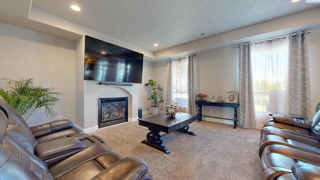 5802 Sidon Ln, Pasco, WA 99301 - carpeted living room featuring a glass covered fireplace, recessed lighting, and a raised ceiling