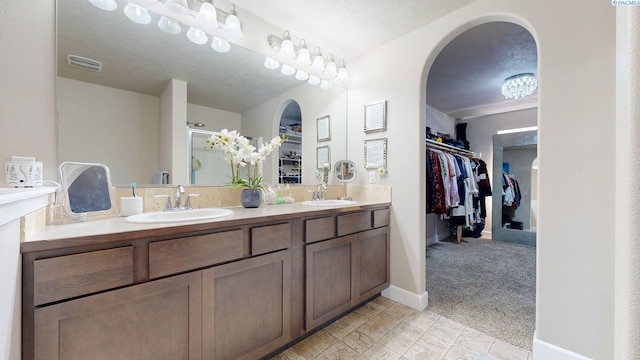 5802 Sidon Ln, Pasco, WA 99301 - bathroom featuring a spacious closet, double vanity, and a shower stall