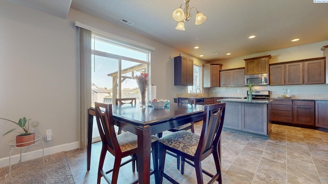 5802 Sidon Ln, Pasco, WA 99301 - dining room with a chandelier, recessed lighting, and light stone finish floors