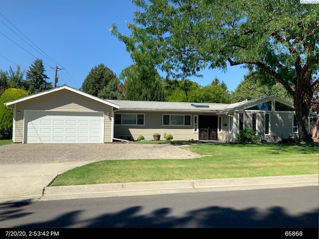 76 Park St, Richland, WA 99354 - view of front of property with a garage, a front lawn, and concrete driveway