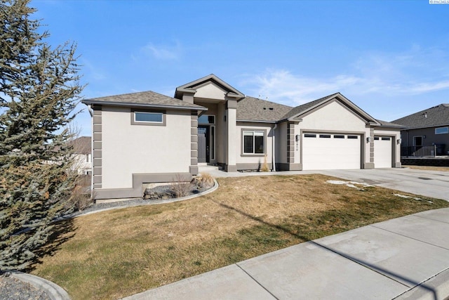 single story home featuring a garage, driveway, a front yard, and stucco siding