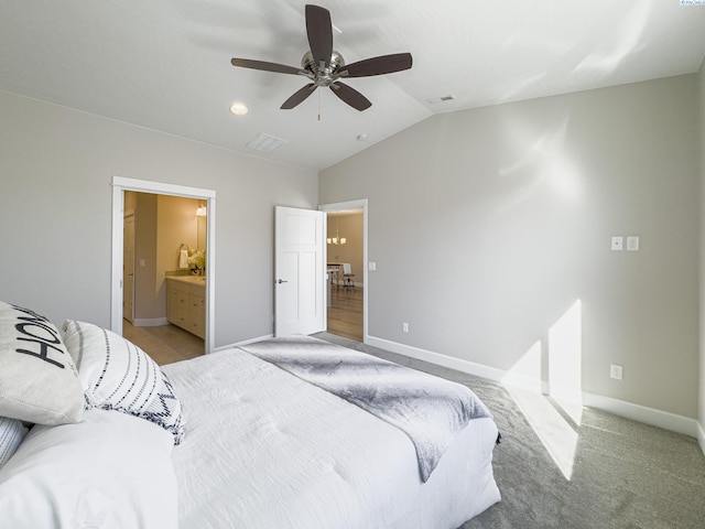 bedroom featuring baseboards, visible vents, vaulted ceiling, and light colored carpet