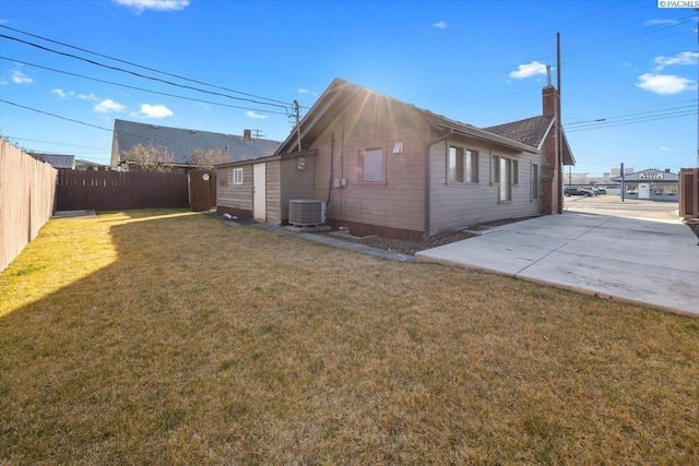 view of home's exterior featuring a yard, a patio area, fence, and central air condition unit