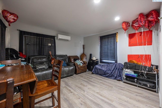 bedroom featuring a wall mounted AC and wood finished floors