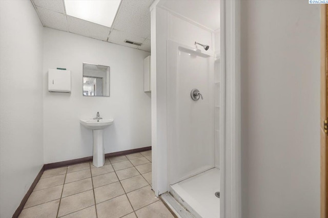 full bathroom with visible vents, a shower stall, a drop ceiling, and tile patterned floors