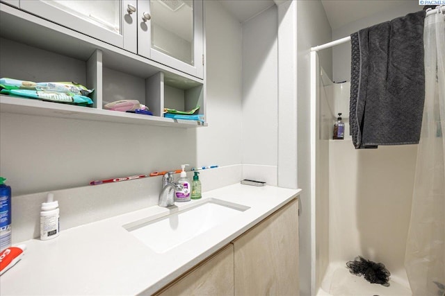 full bath featuring a stall shower and vanity