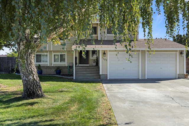 front of property featuring a front yard and a garage