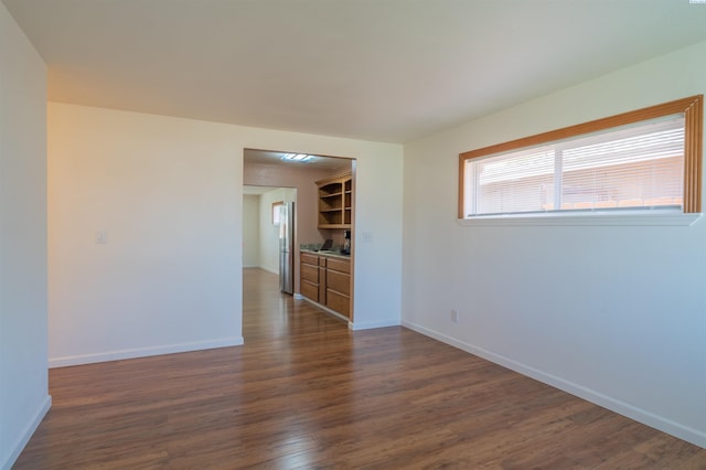 empty room featuring dark hardwood / wood-style flooring