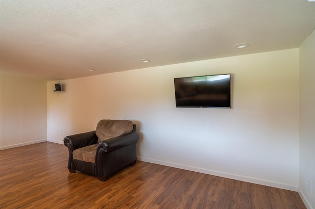 sitting room with dark hardwood / wood-style flooring