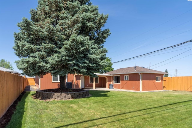 rear view of property featuring a yard