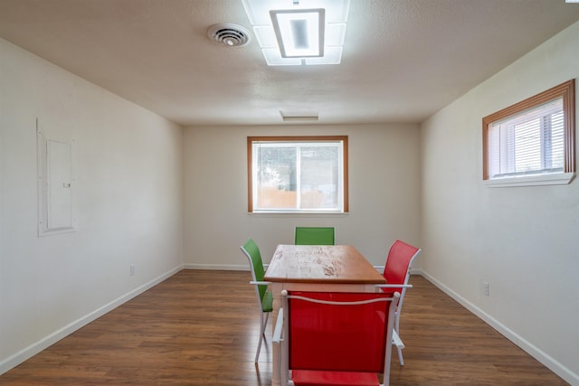 dining space featuring dark wood-type flooring and electric panel