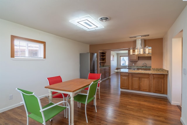 dining area with dark hardwood / wood-style floors