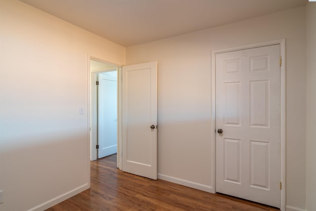 unfurnished bedroom featuring dark hardwood / wood-style floors