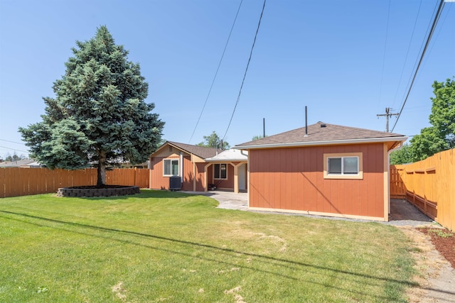 rear view of property with a yard and an outdoor structure