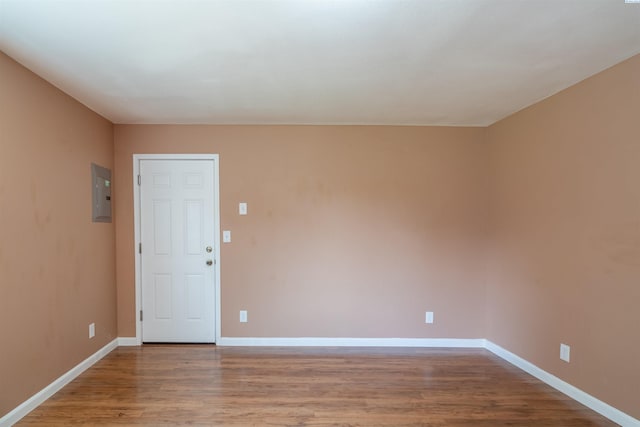 spare room with hardwood / wood-style flooring and electric panel