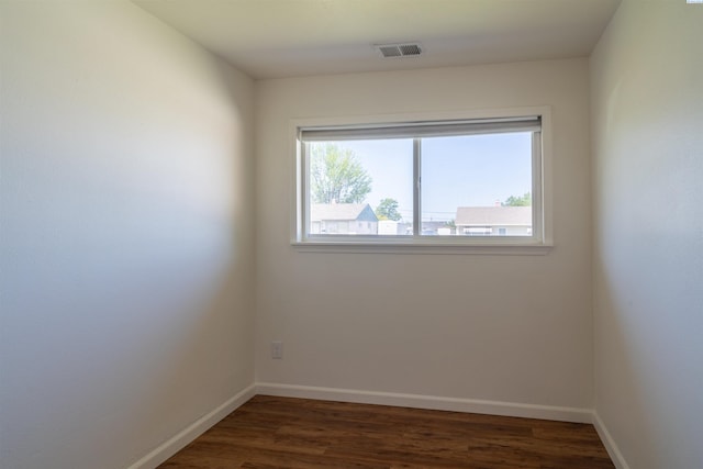 empty room with dark wood-type flooring