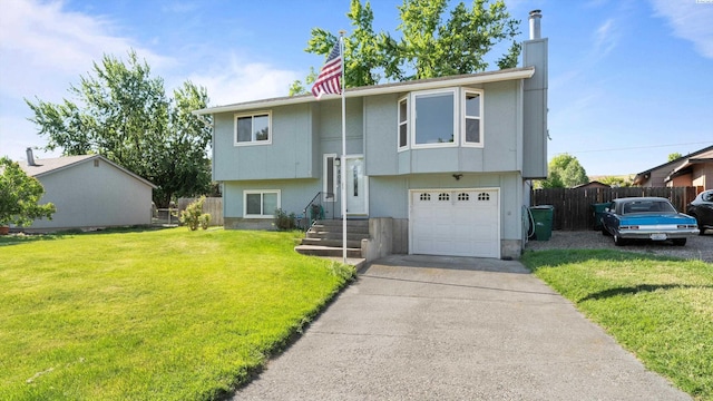 805 W 44th Pl, Kennewick, WA 99337 - split foyer home with a garage, driveway, and a chimney