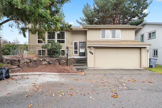 split foyer home with aphalt driveway and an attached garage