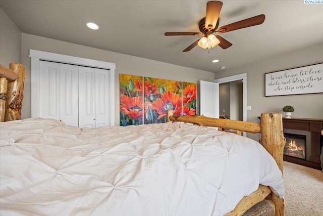 168715 W Johnson Rd, Prosser, WA 99350 - carpeted bedroom featuring a closet, a glass covered fireplace, a ceiling fan, and recessed lighting