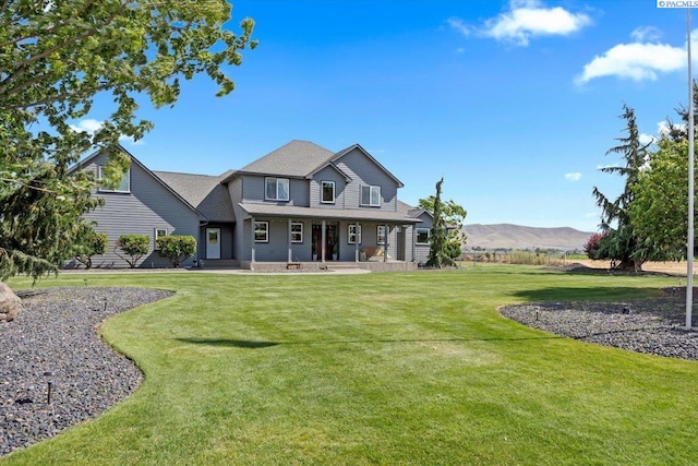 168715 W Johnson Rd, Prosser, WA 99350 - view of front of home with a porch, a front yard, and a mountain view