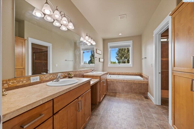 168715 W Johnson Rd, Prosser, WA 99350 - bathroom with a garden tub, vanity, tiled shower, and tile patterned flooring