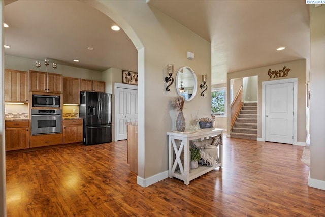 168715 W Johnson Rd, Prosser, WA 99350 - kitchen featuring stainless steel appliances, arched walkways, dark wood-style flooring, baseboards, and recessed lighting