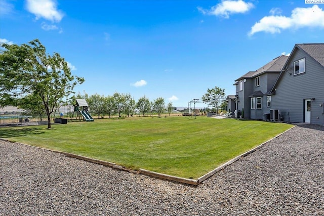 168715 W Johnson Rd, Prosser, WA 99350 - view of grassy yard featuring a playground and central air condition unit