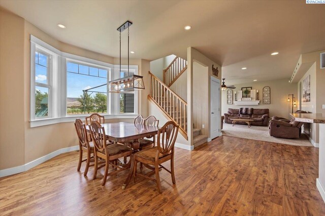 168715 W Johnson Rd, Prosser, WA 99350 - dining room featuring stairs, wood finished floors, baseboards, ceiling fan, and recessed lighting