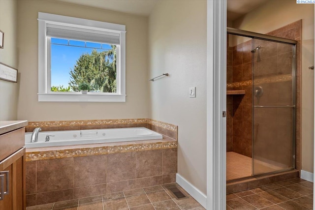 168715 W Johnson Rd, Prosser, WA 99350 - bathroom featuring a garden tub, a stall shower, tile patterned flooring, vanity, and baseboards